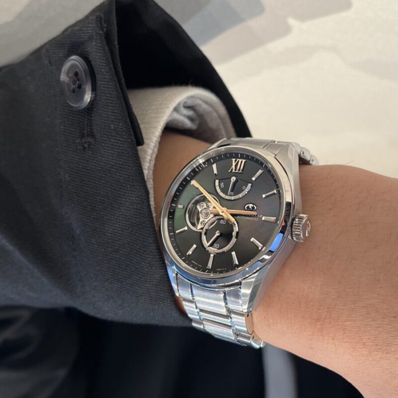 オリエントスターの時計を着ける男性の手元